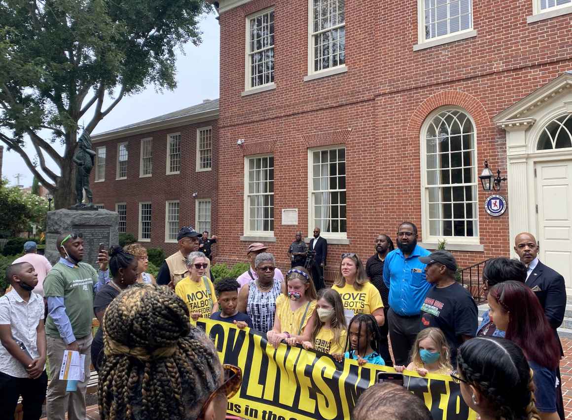 2021 Freedom Riders protest at courthouse in Easton, Maryland, next to a Confederate statue. The protesters hold a Black Lives Matter banner.