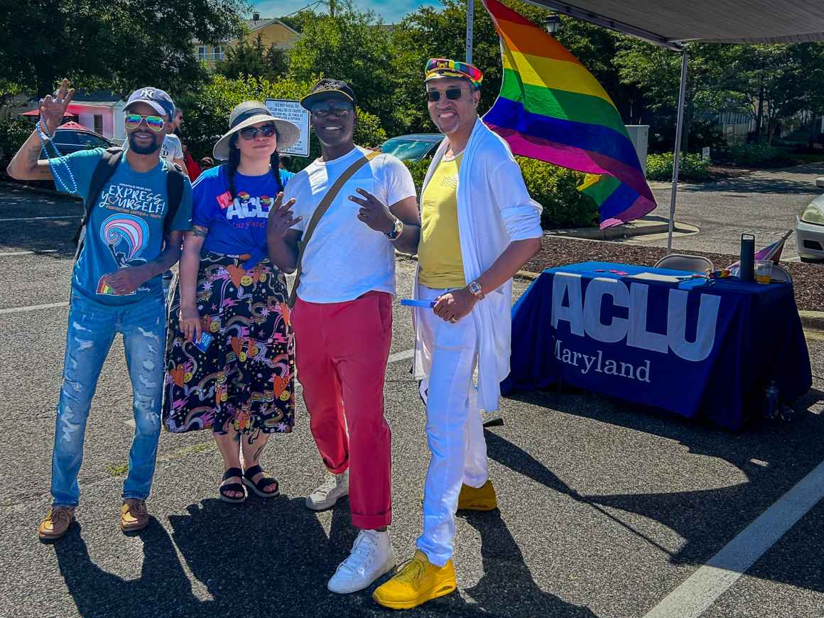 Nicole McCann standing with a few people in front of the ACLU of Maryland table at Annapolis Pride.