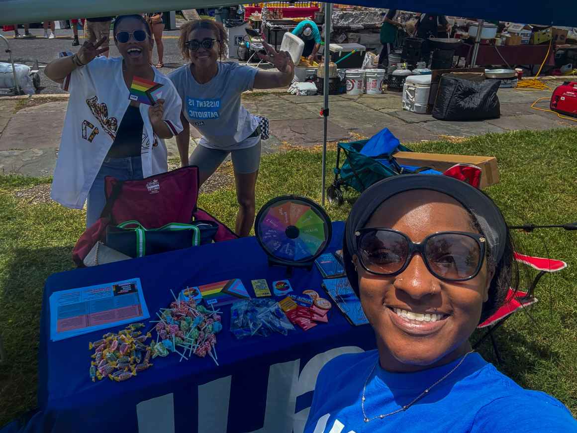 Rebecca M. Phillips, Veronica Dunlap, and Syndey Moore at the ACLU of Maryland table at Baltimore City Pride.